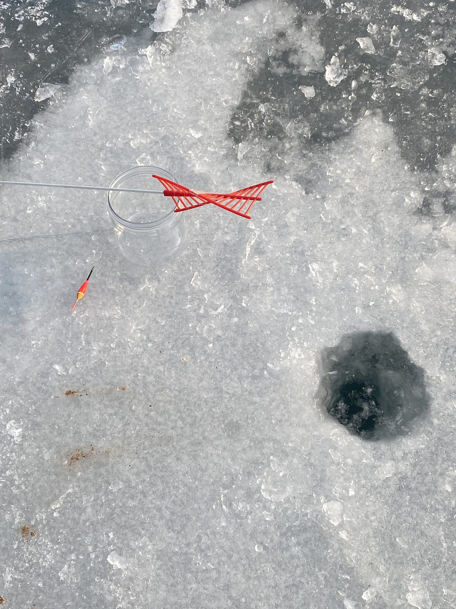Ice fishing on a frozen lake